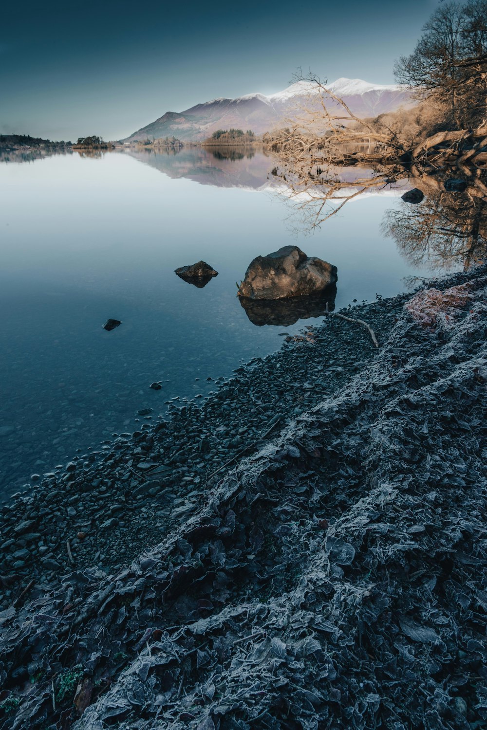 a body of water surrounded by a rocky shore