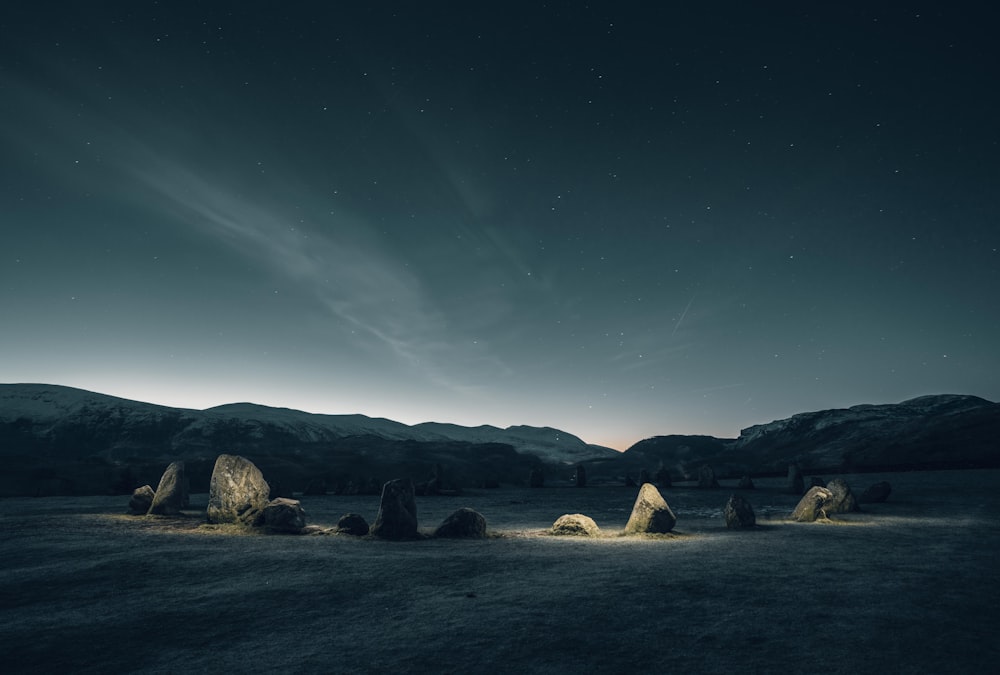 a group of rocks sitting in the middle of a field