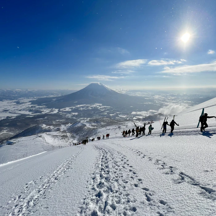 Skiers hiking a ridge above Mt. Yotei in Niseko