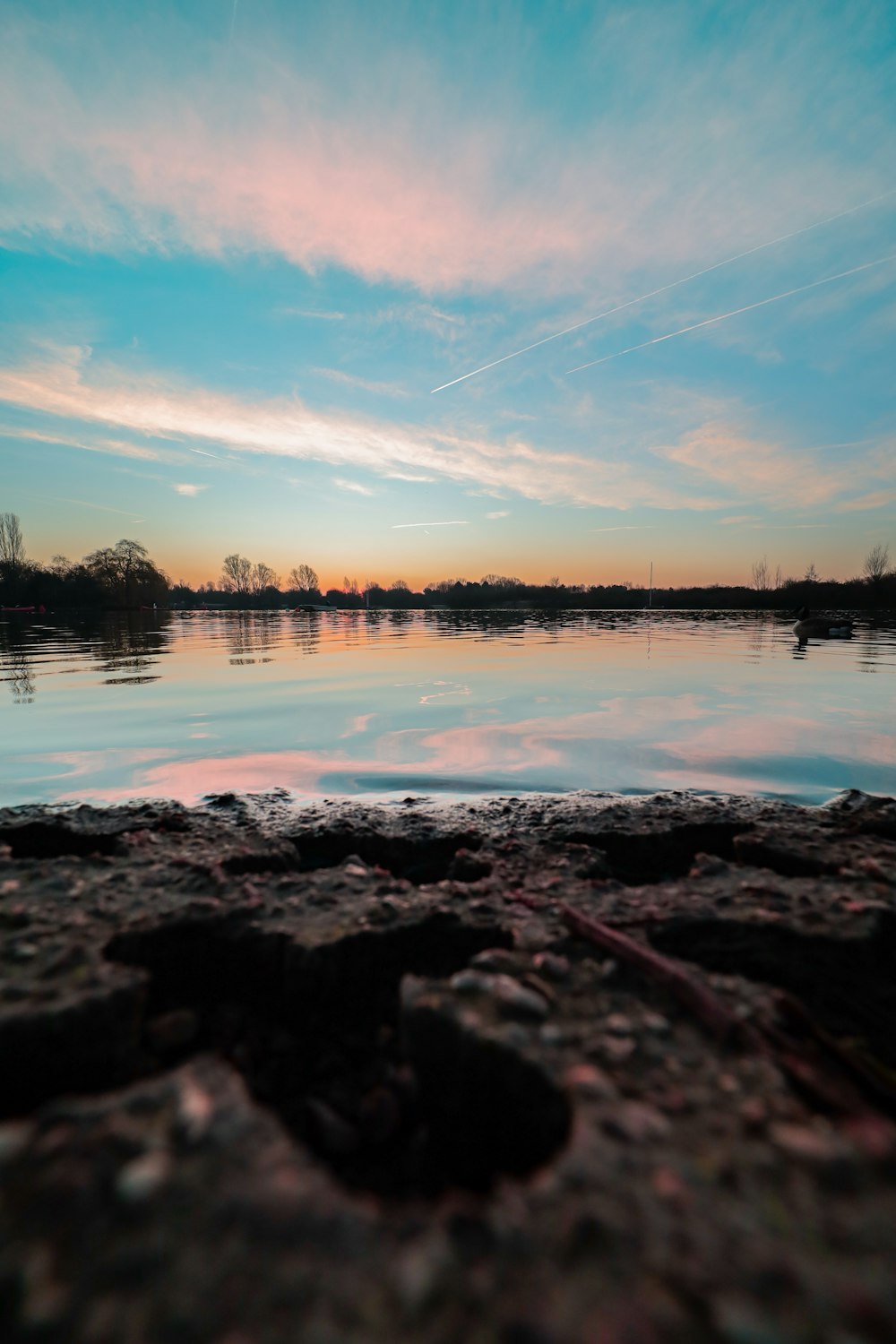 a body of water with a sky in the background