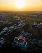A cinematic aerial shot of a luxury real estate development at sunset.