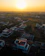 A vibrant aerial shot of a sprawling residential property taken at golden hour.