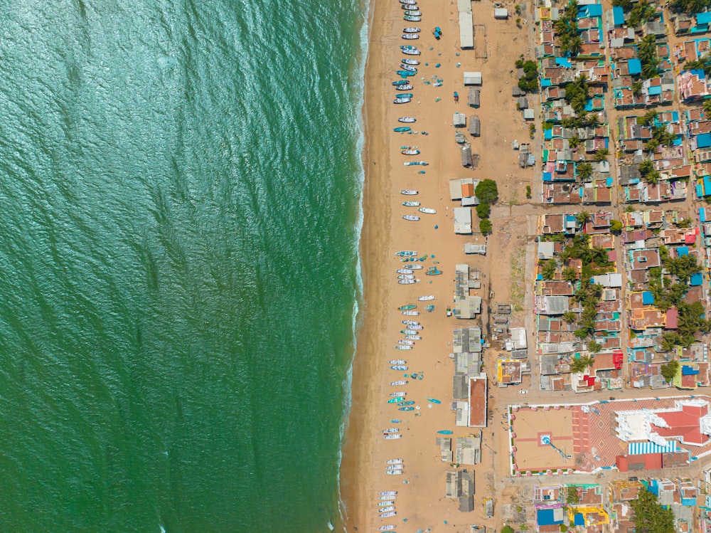 an aerial view of a beach with a lot of boats