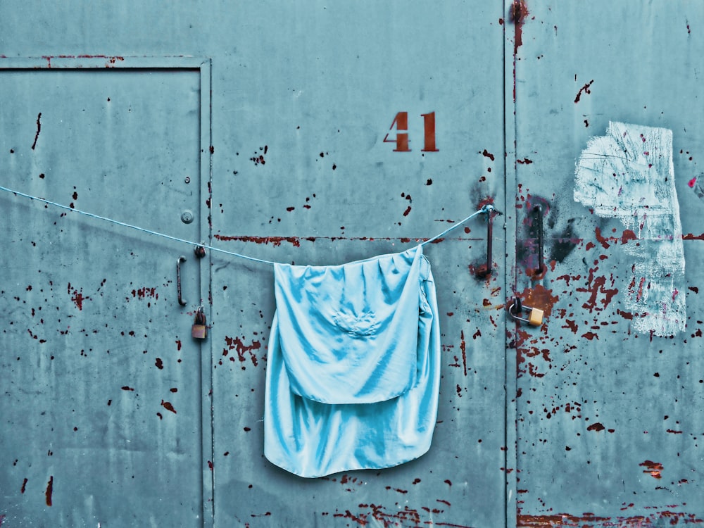 a blue towel hanging on a clothes line