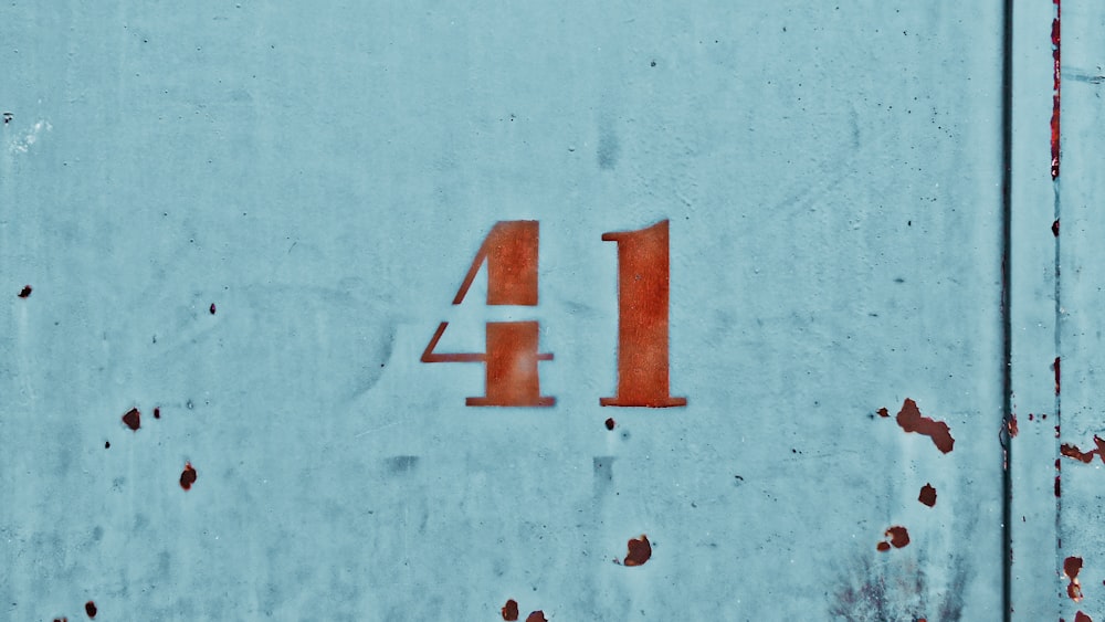 a close up of the number four on a wall