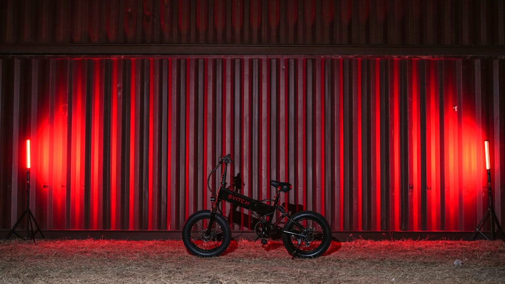 a bike parked in front of a red wall