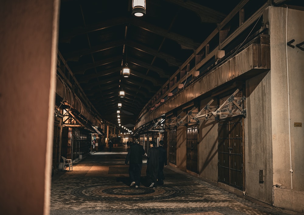 a couple of people that are standing in a hallway