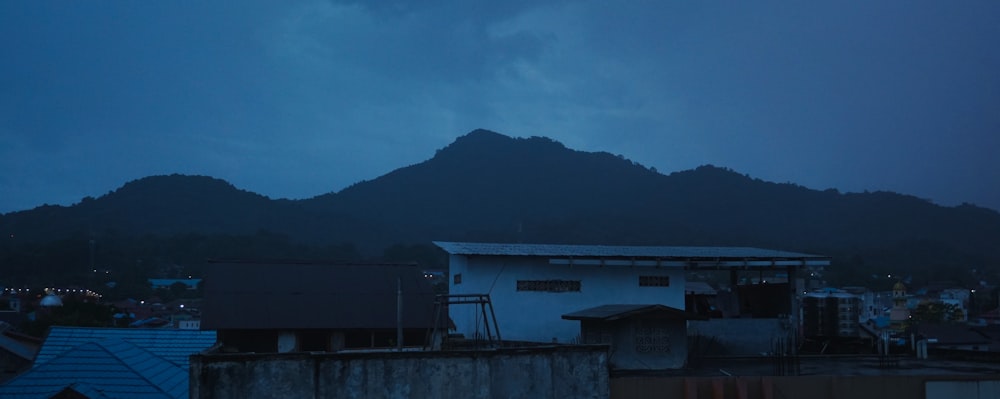 a dark sky with a mountain in the background