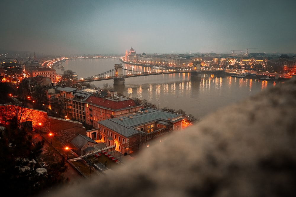 a view of a bridge over a river at night