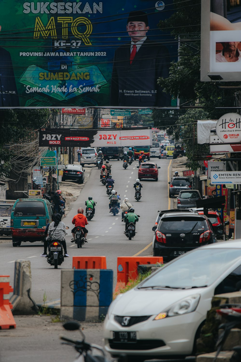 a group of people riding motorcycles down a street