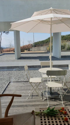 A sleek rectangular outdoor table with a smooth surface, placed on a wooden deck