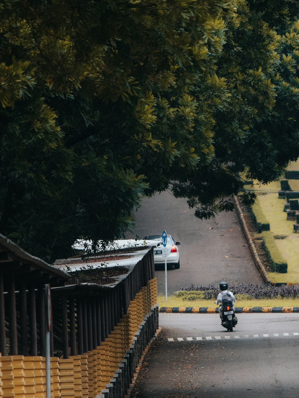 a person riding a motorcycle down a street