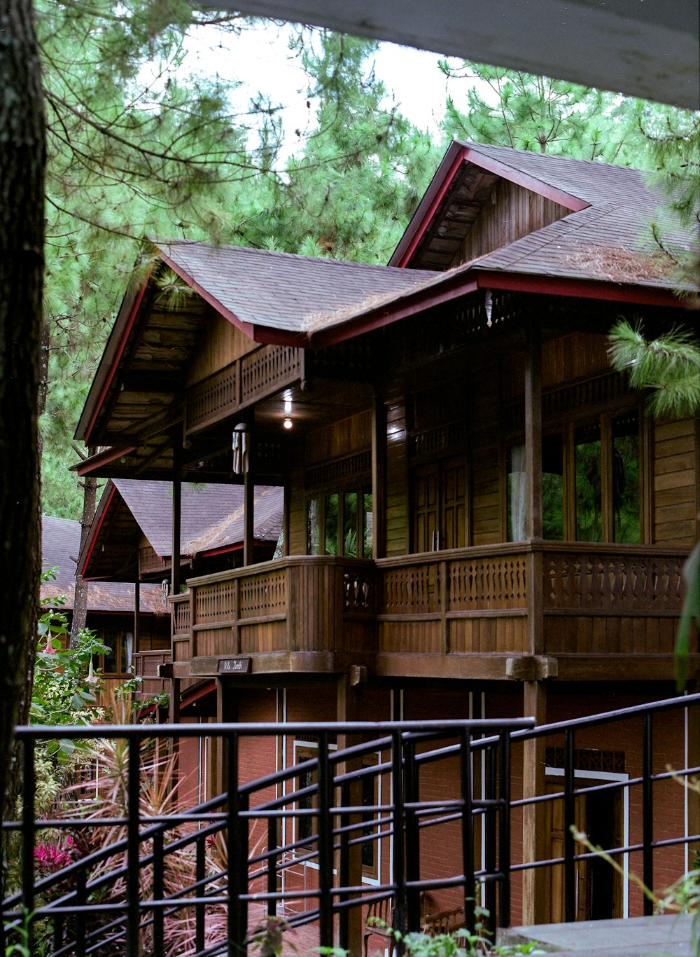 a wooden house surrounded by trees in a forest