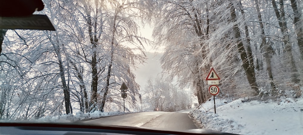 a car driving down a snow covered road