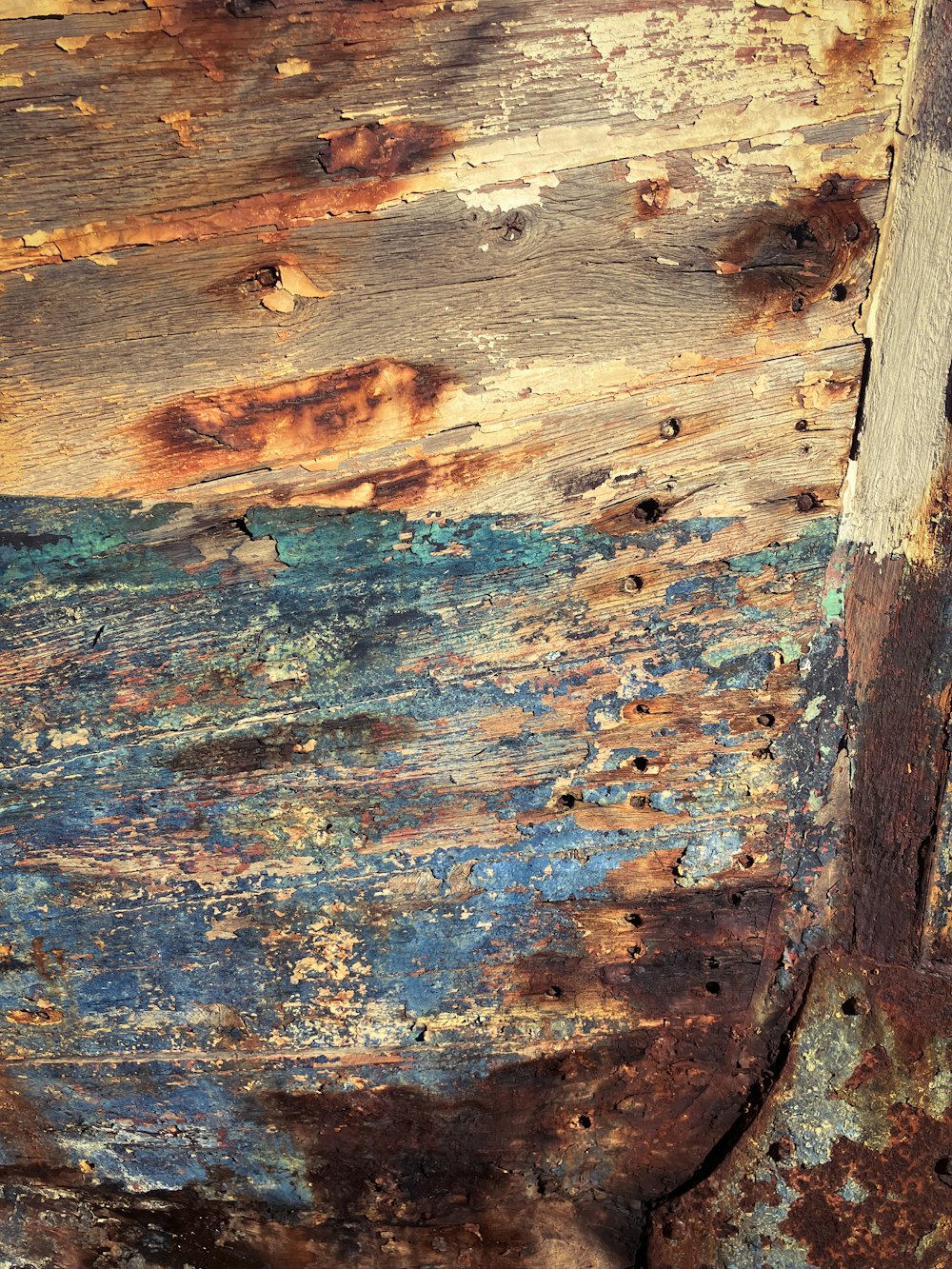 a close up of a wooden surface with peeling paint