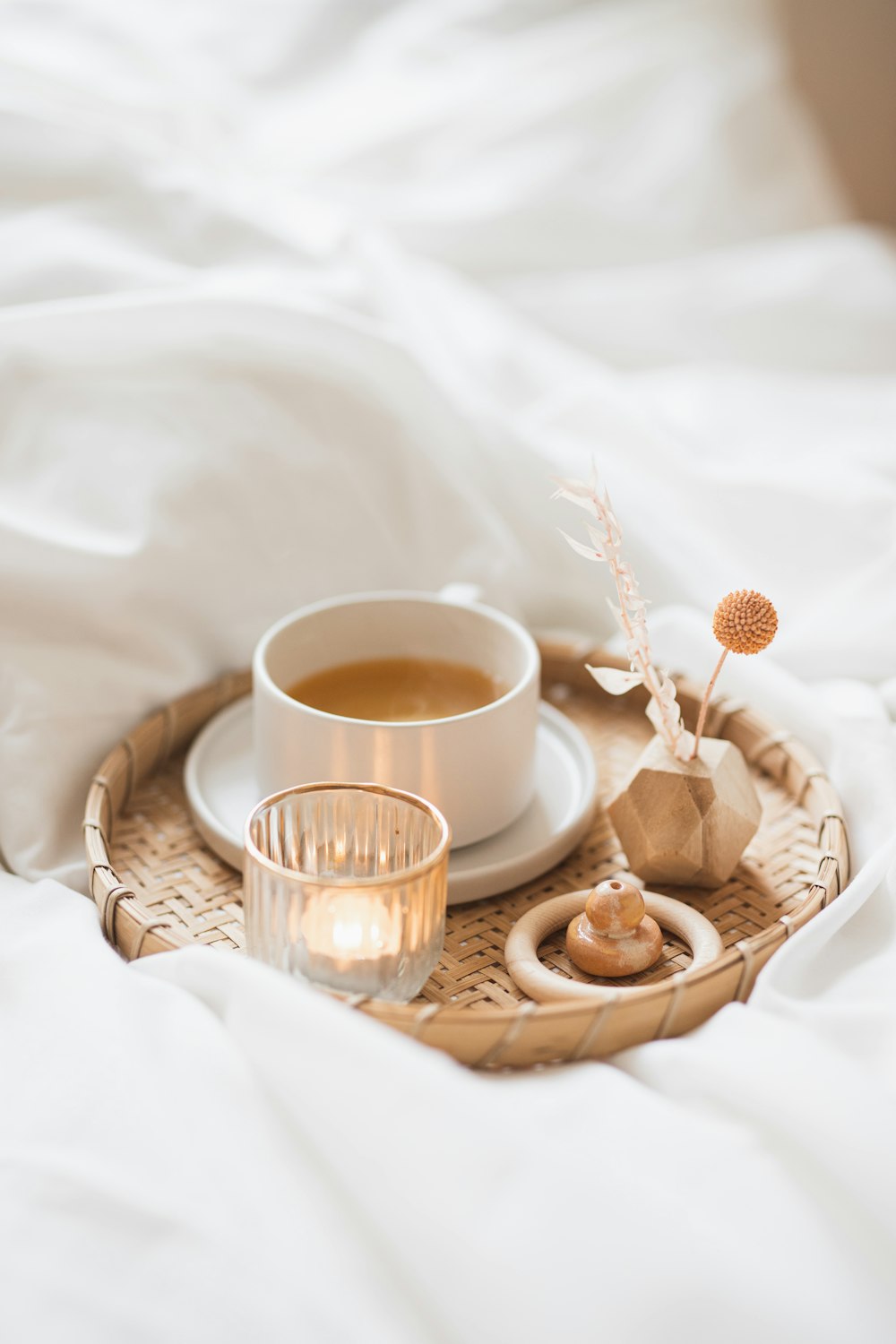 a tray with a cup of coffee and a candle on it