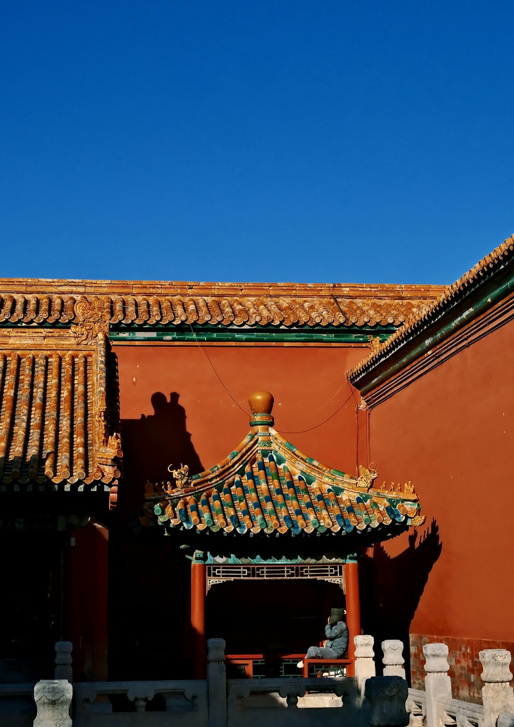 a red building with a blue sky in the background