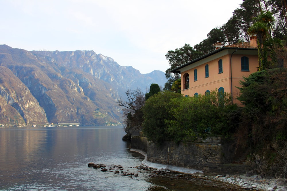 a large body of water with a house on the side of it