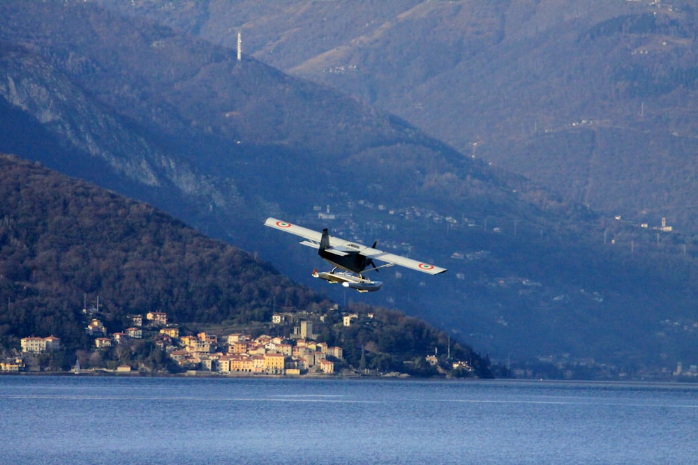 a small plane flying over a body of water