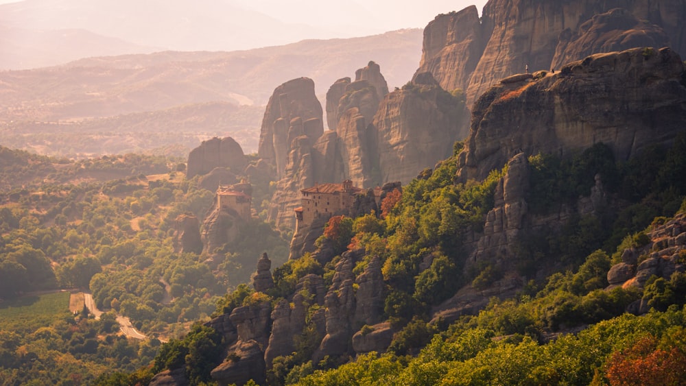 a scenic view of a mountain range with a castle in the middle