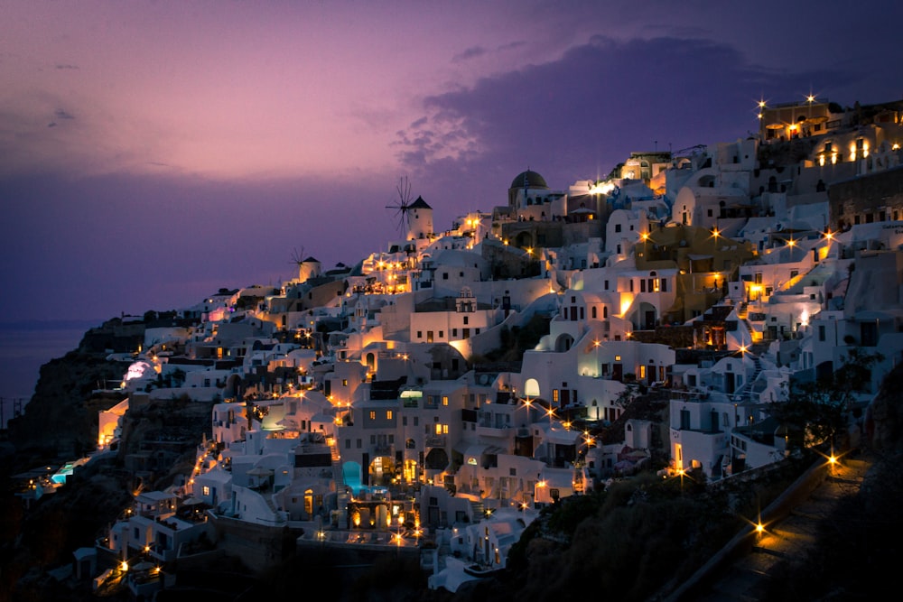 a night time view of a town on a hill