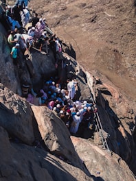 a group of people climbing up the side of a mountain