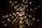 A burst of warm, yellow lights appears against a dark background, resembling sparklers or festively arranged fairy lights. The lights are blurred, giving a sense of motion and a dynamic visual effect.