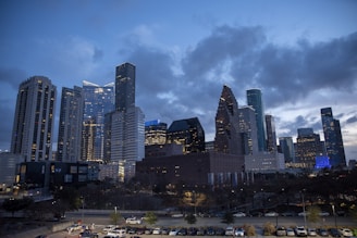 City skyline showing diverse modern architecture at dusk.