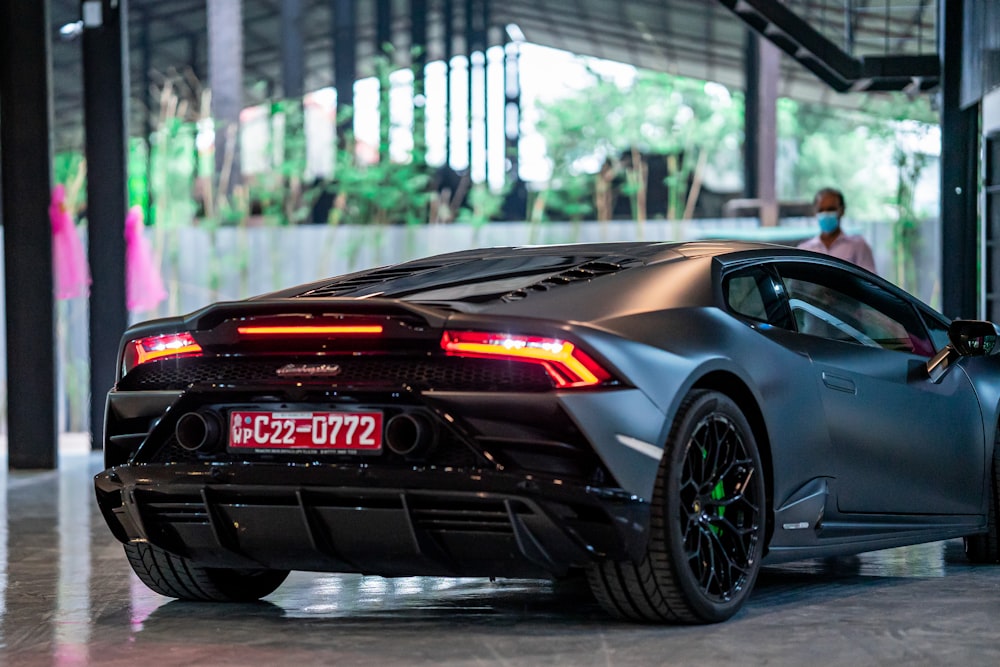 a black sports car parked in a garage