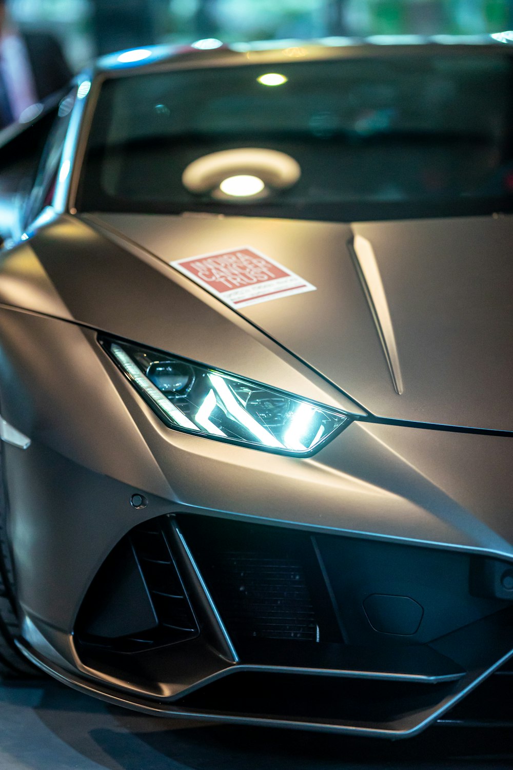 a silver sports car parked in a showroom