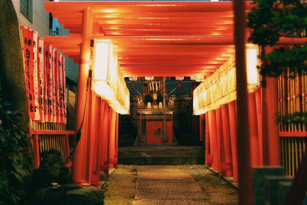 a walkway that has a lot of red curtains on it