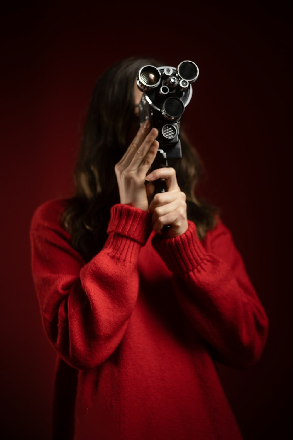 a woman holding a camera up to her face