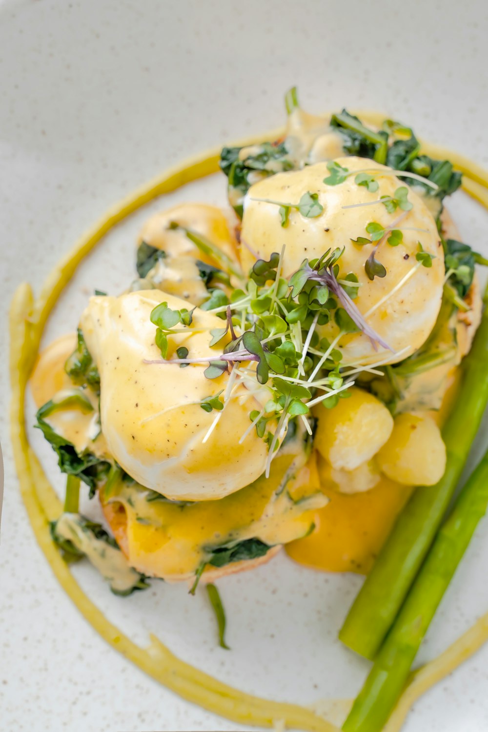 a plate of food with asparagus and eggs