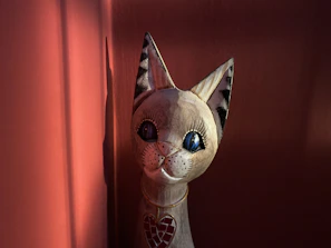 Close-up of a hand-painted wooden cat figurine with delicate details.