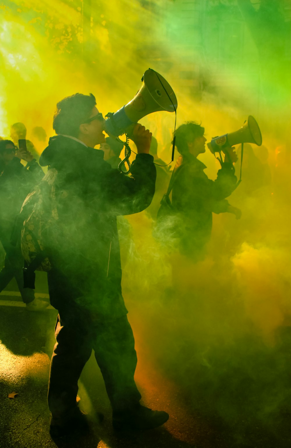 a group of people standing around with smoke