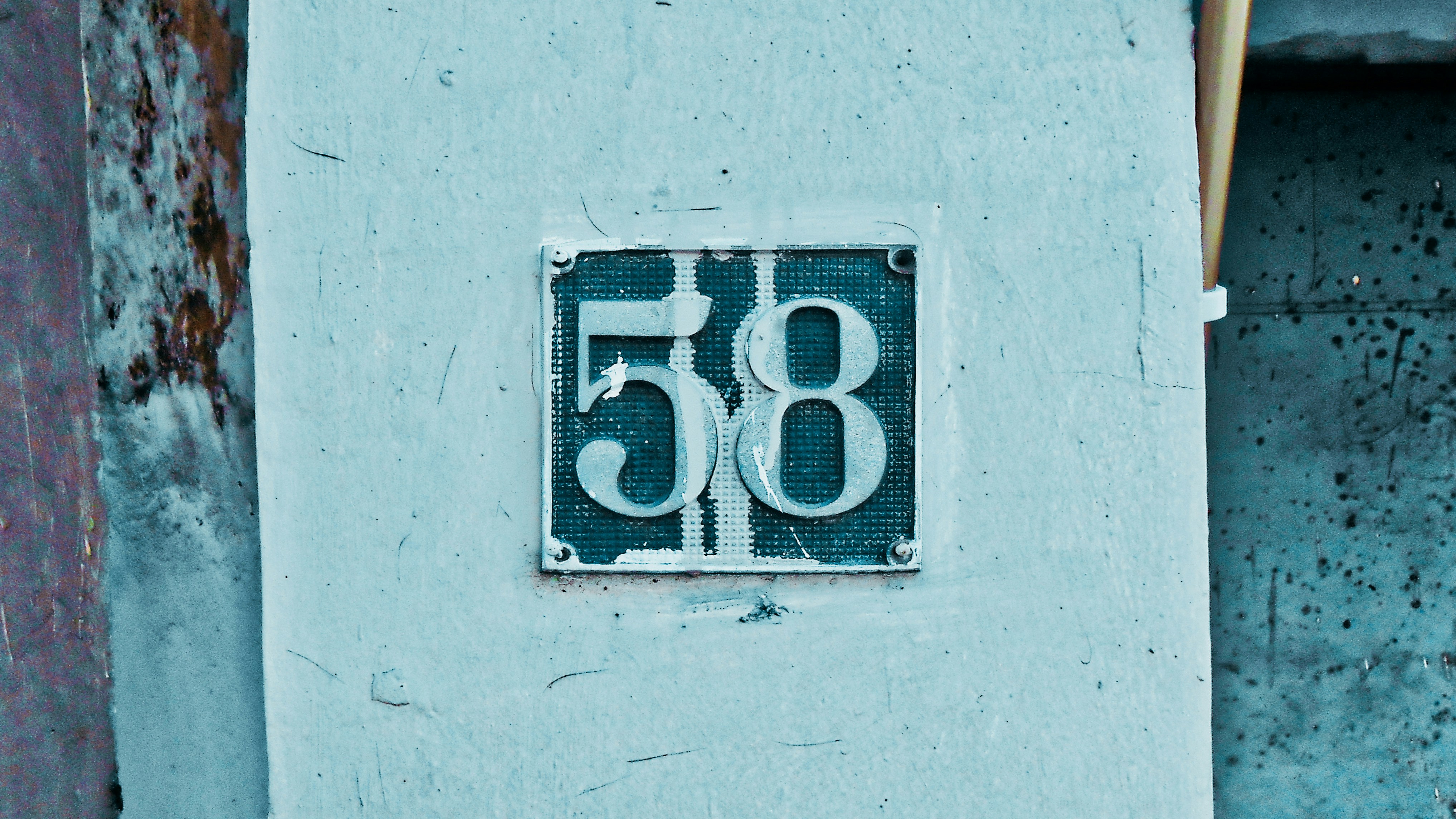 a number sign on the side of a building