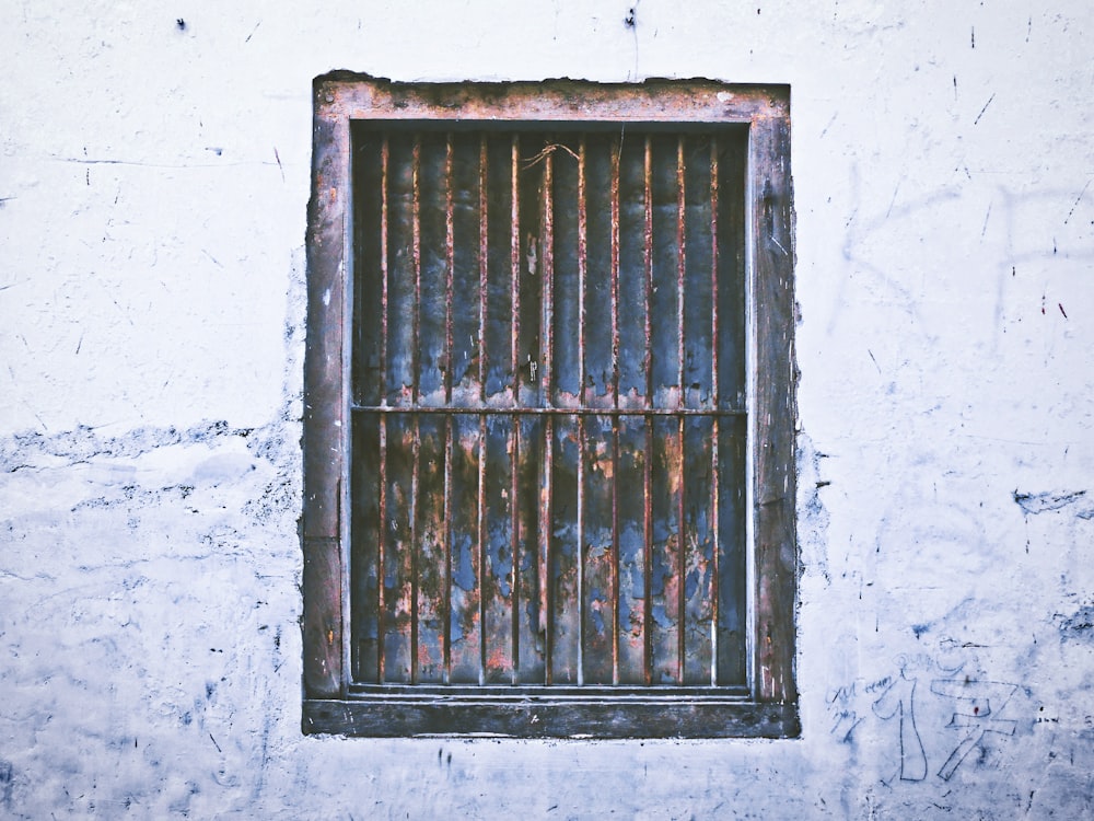a barred window on the side of a building