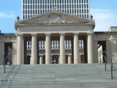 a large building with columns and a clock on top of it