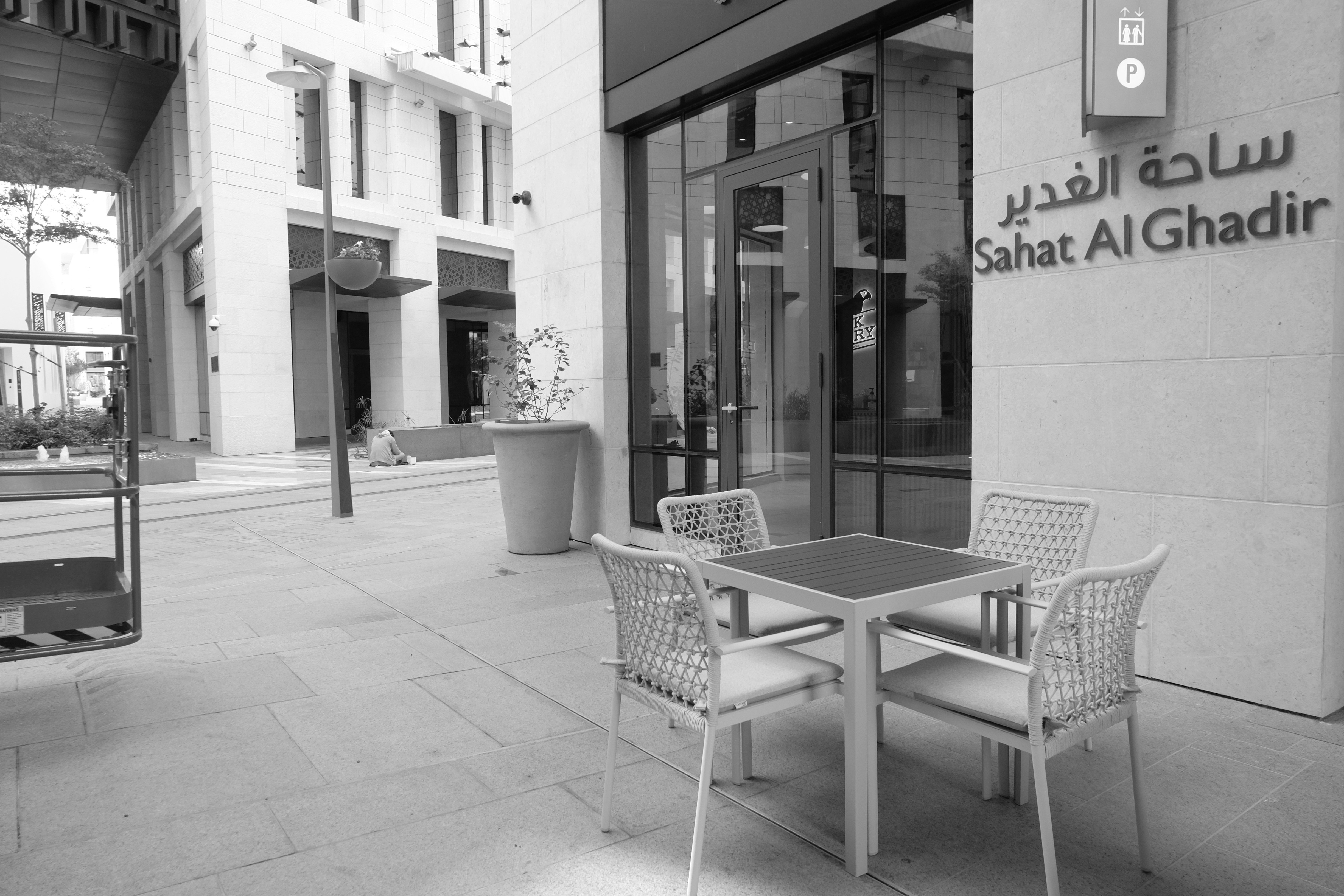 a black and white photo of a table and chairs