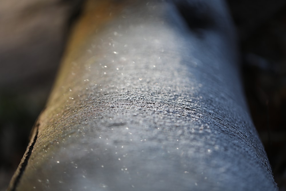 a close up of a metal pipe with water droplets on it