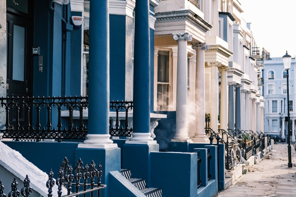 a row of blue and white buildings on a city street