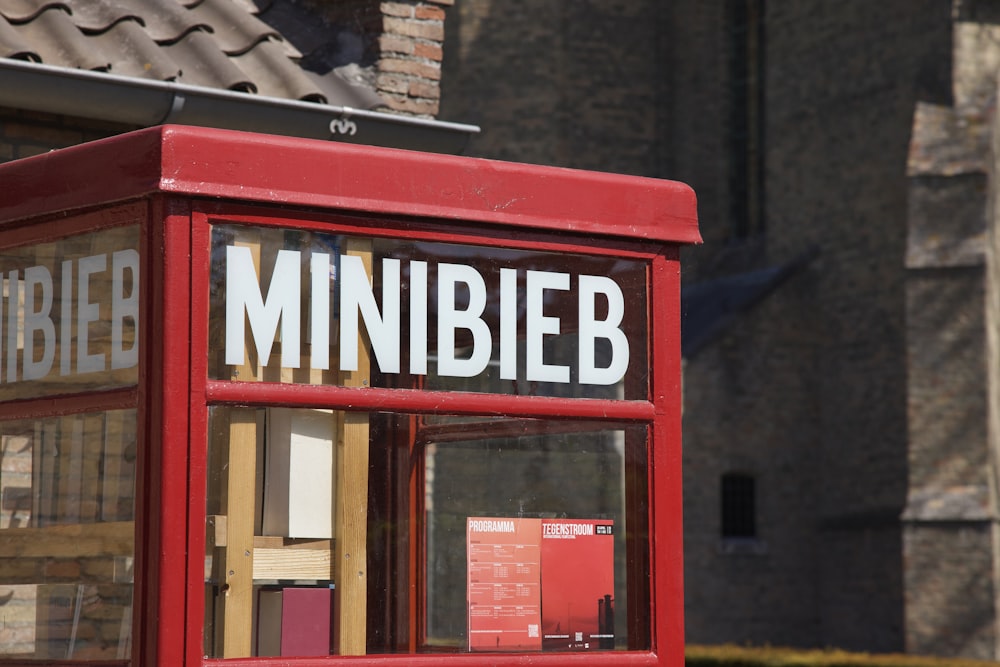 a red phone booth with a sign that says mininibe
