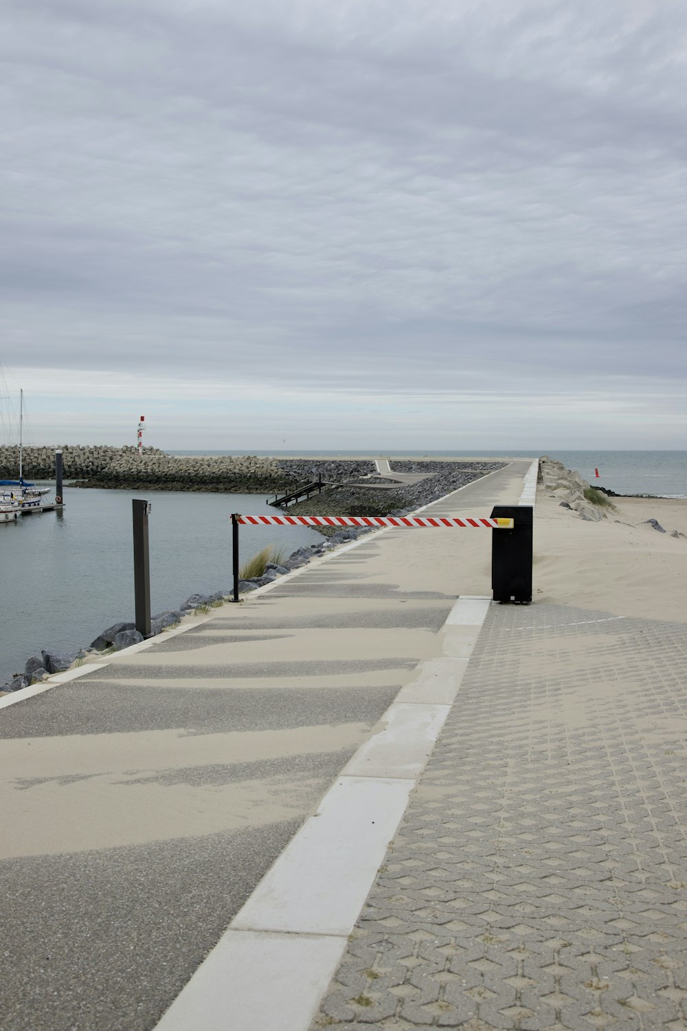 a sidewalk next to a body of water