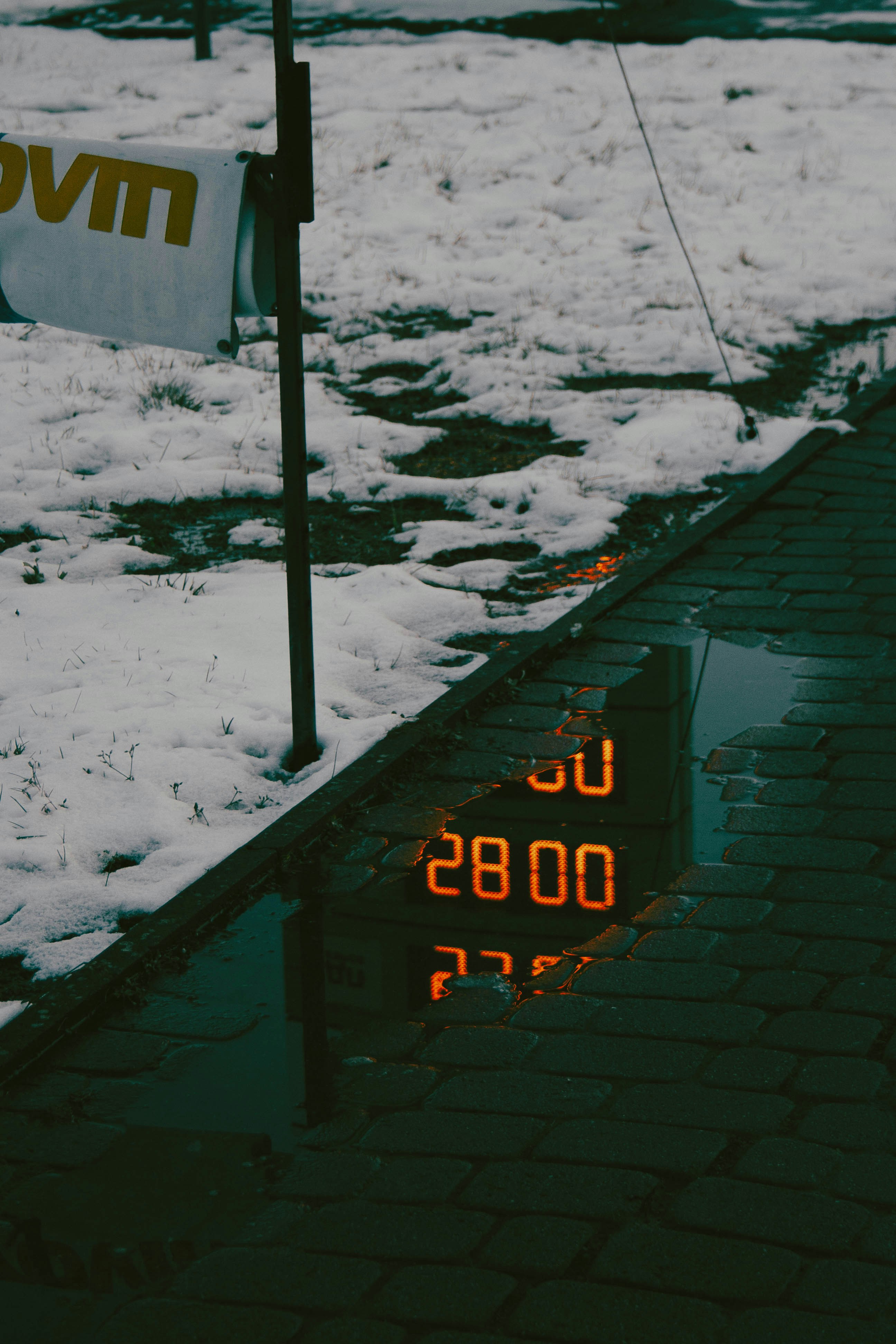 a clock that is sitting in the snow
