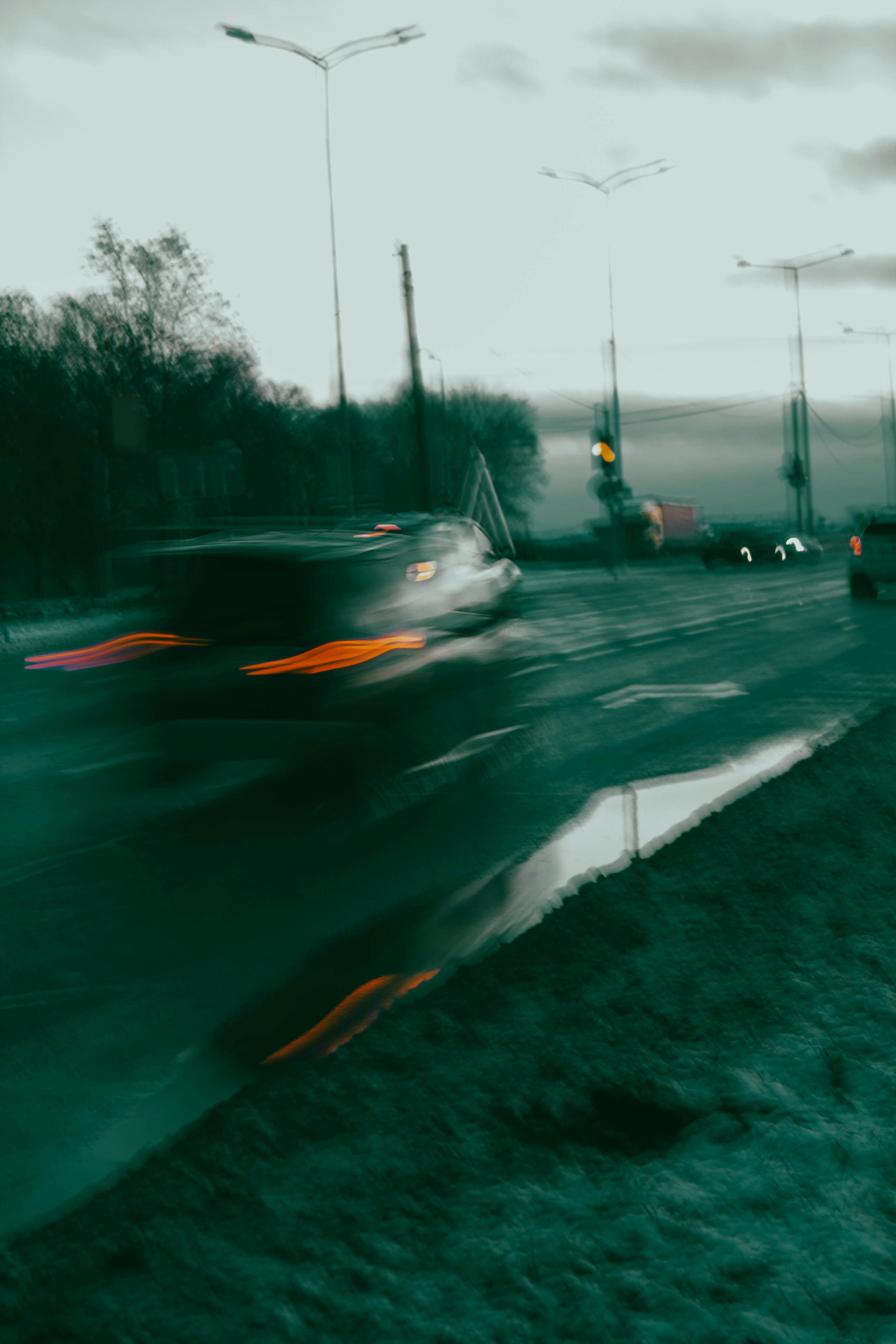 A blurry photo of a car driving down a road