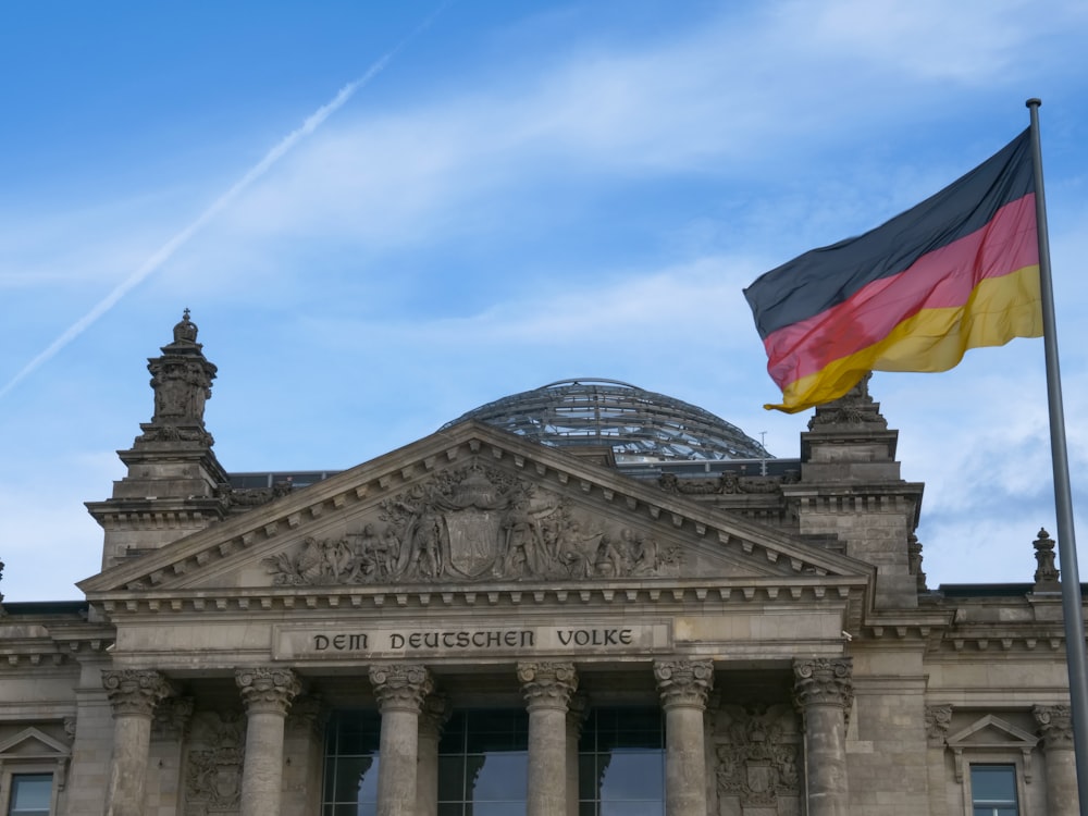 a german flag flying in front of a building