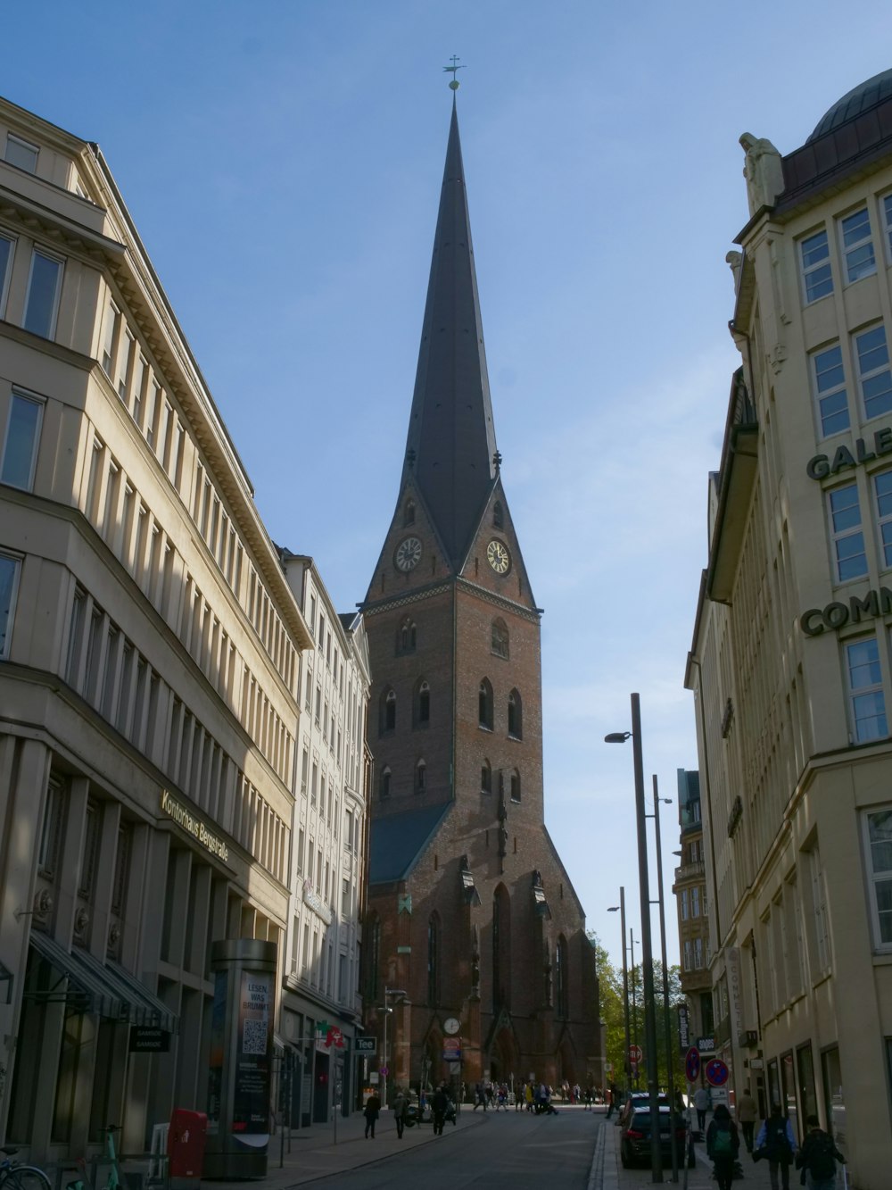 a church steeple towering over a city street
