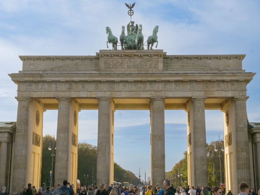 a group of people standing in front of a monument