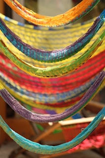 Various styles of colorful nets and hammocks displayed neatly in the store