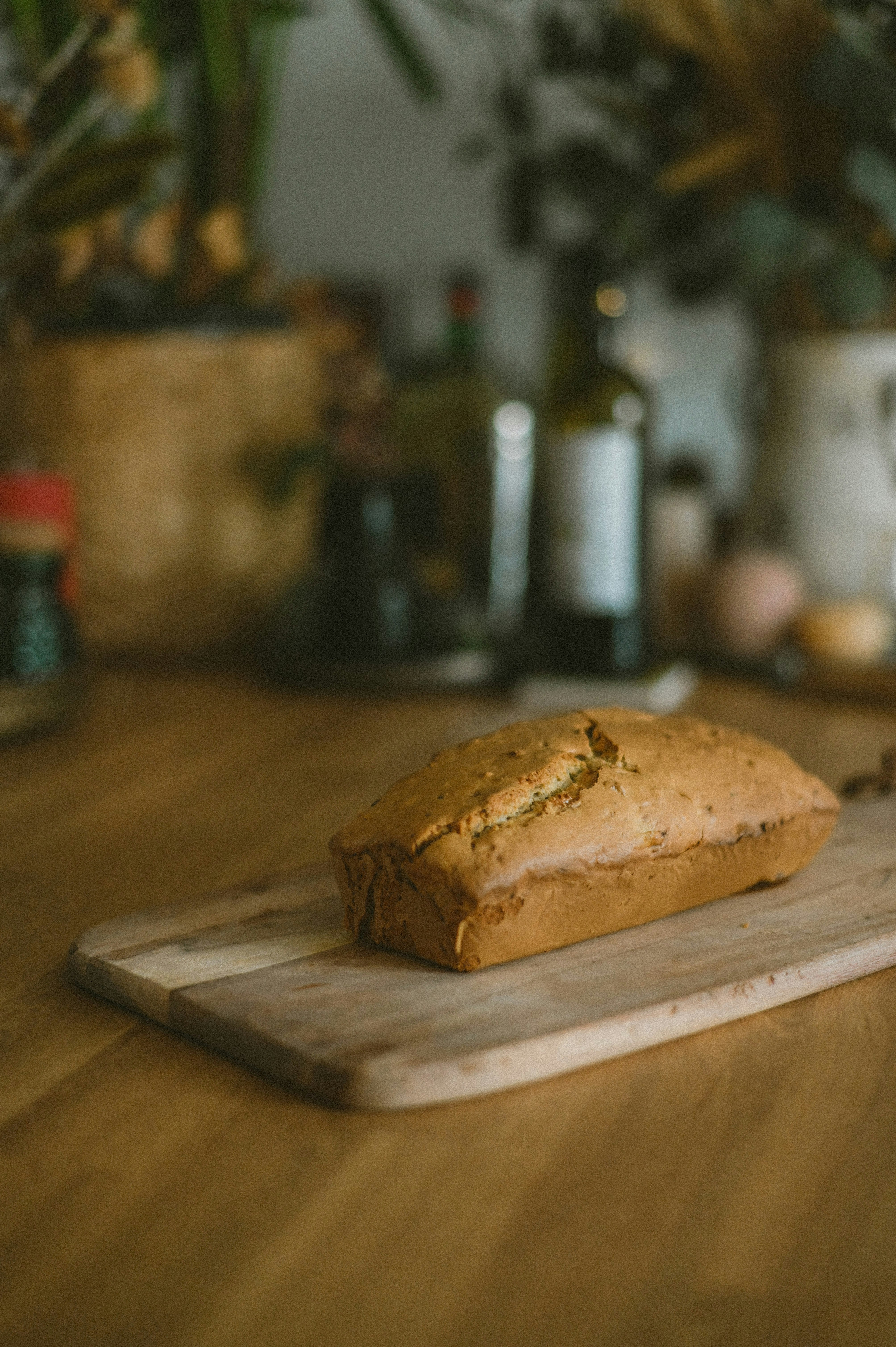 a loaf of bread sitting on top of a wooden cutting board